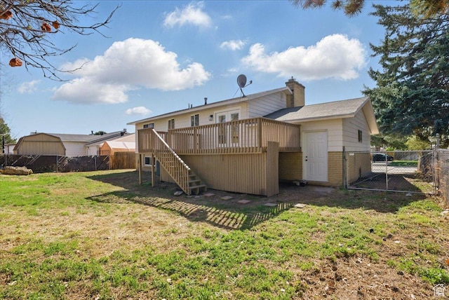 back of property featuring a yard, fence, stairs, a wooden deck, and a gate