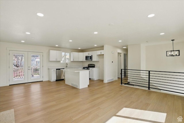 kitchen with light wood-style flooring, white cabinetry, recessed lighting, and stainless steel appliances