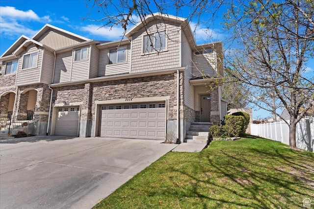 view of front of house with a garage, a front yard, stone siding, and fence