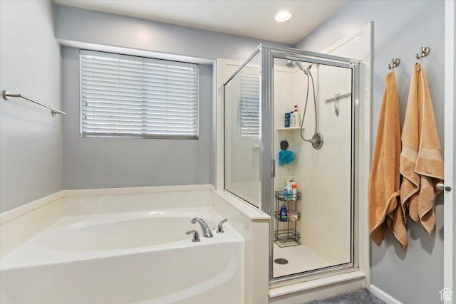 bathroom with a bath and a stall shower
