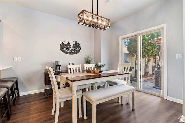 dining room featuring baseboards, a chandelier, and dark wood finished floors