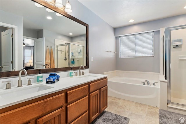 full bathroom featuring a shower stall, a bath, a healthy amount of sunlight, and a sink