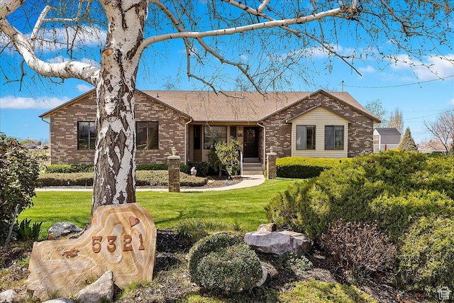 ranch-style home with brick siding and a front lawn