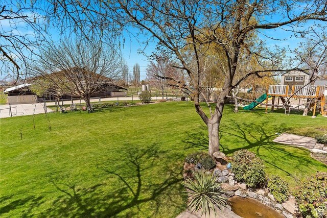 view of yard with playground community and fence