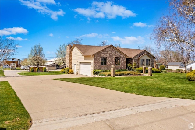 ranch-style house featuring a front yard, a chimney, an attached garage, and concrete driveway