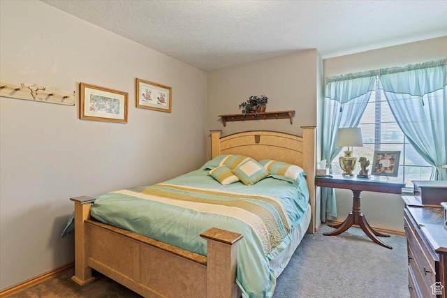 bedroom with carpet flooring and a textured ceiling