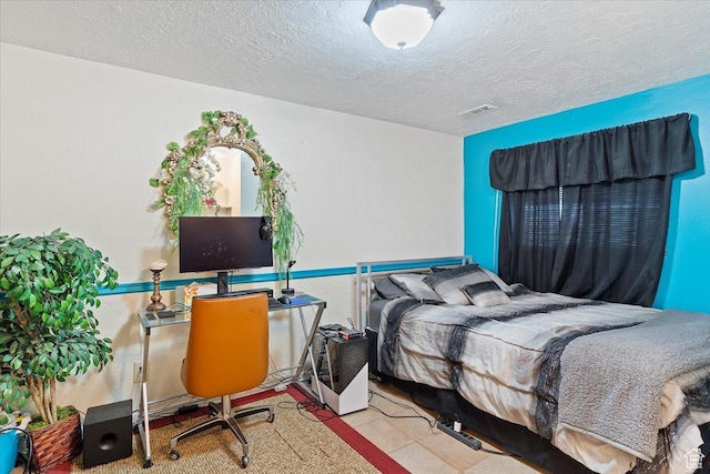 bedroom with visible vents and a textured ceiling