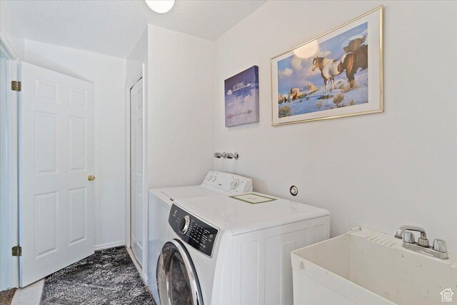 laundry area featuring a sink, separate washer and dryer, and laundry area