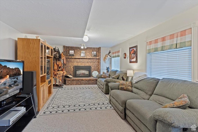 living area featuring carpet floors, a brick fireplace, and a textured ceiling