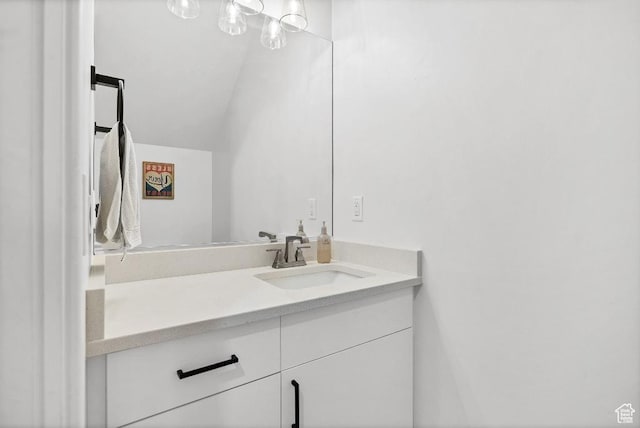 bathroom with vanity and lofted ceiling