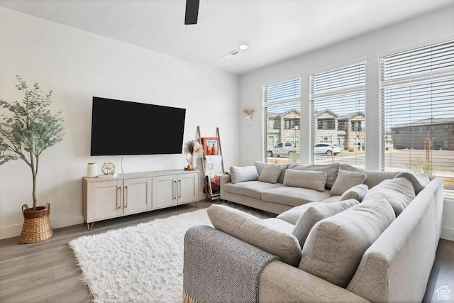 living room with recessed lighting, light wood-style flooring, baseboards, and a ceiling fan