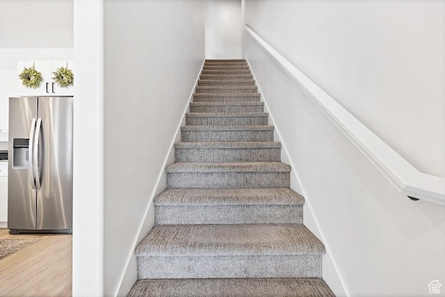 stairs featuring baseboards and wood finished floors