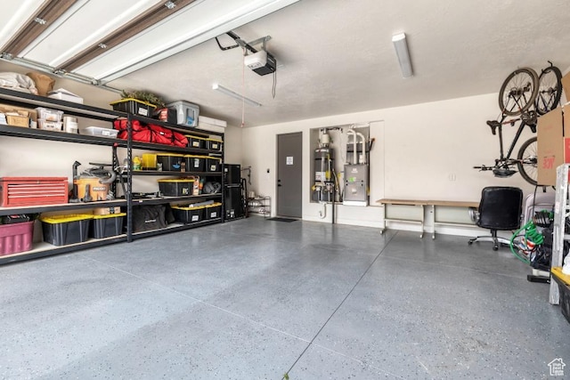 garage featuring strapped water heater and a garage door opener