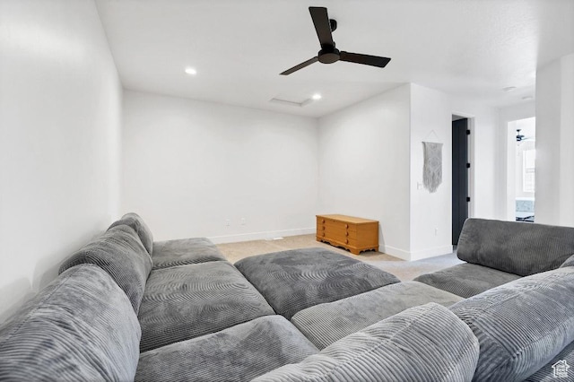 living area featuring baseboards, recessed lighting, ceiling fan, and light carpet