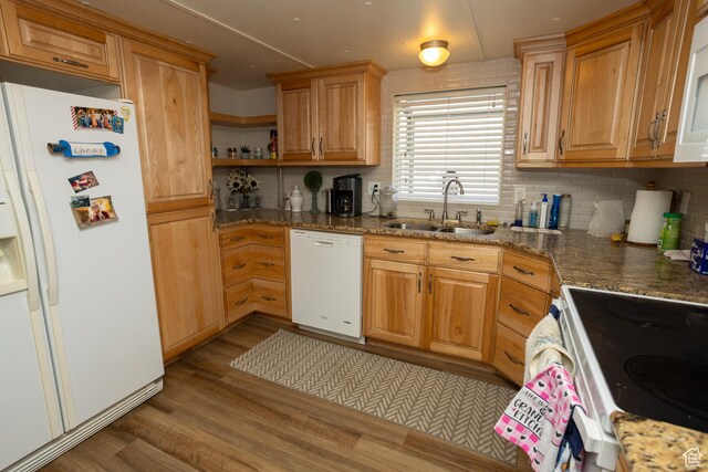 145 S 100 E, Redmond, UT 84652 - kitchen with dark stone countertops, white appliances, backsplash, a sink, and wood finished floors