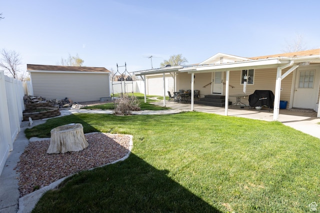 145 S 100 E, Redmond, UT 84652 - view of yard with entry steps, a storage shed, a patio area, a fenced backyard, and an outbuilding