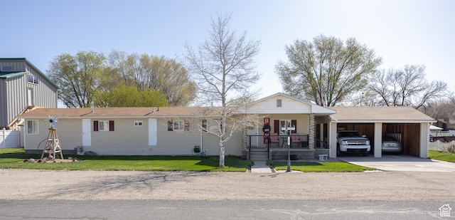view of front of property with a carport, driveway, covered porch, and a front lawn