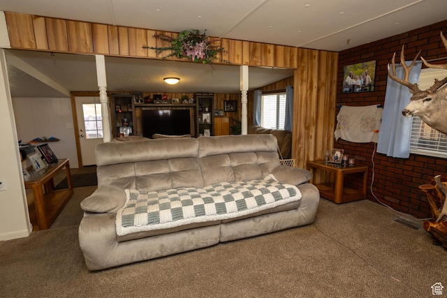 145 S 100 E, Redmond, UT 84652 - living area featuring visible vents, brick wall, wood walls, and carpet