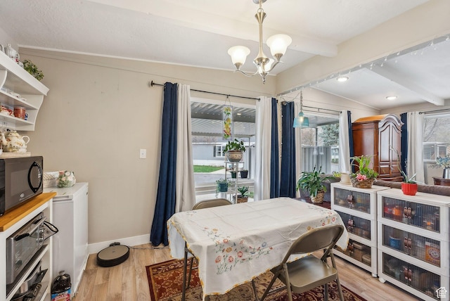 5100 S 1050 W Unit H138, Riverdale, UT 84405 - dining room featuring a wealth of natural light, light wood finished floors, a notable chandelier, and beamed ceiling