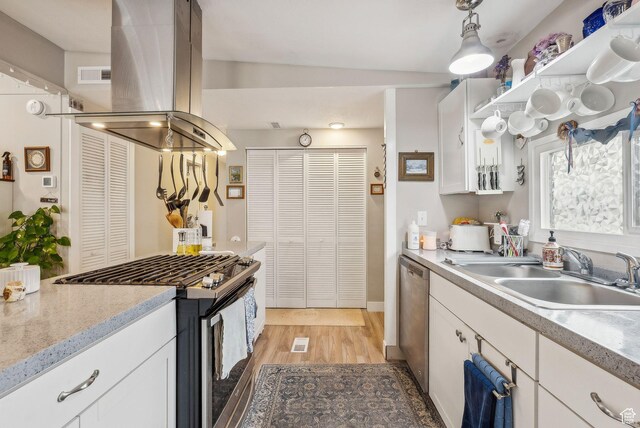 5100 S 1050 W Unit H138, Riverdale, UT 84405 - kitchen featuring light wood-type flooring, white cabinetry, appliances with stainless steel finishes, island exhaust hood, and a sink