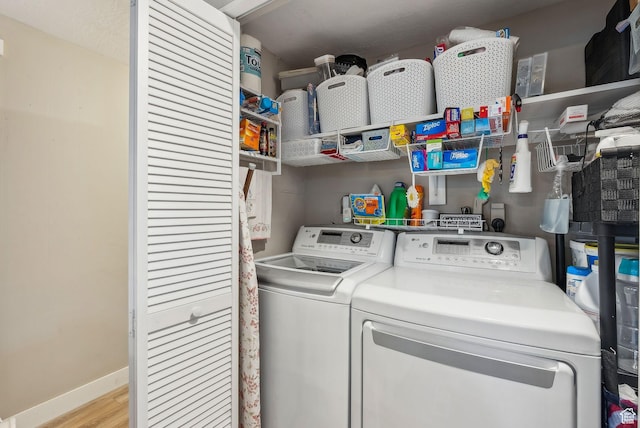 5100 S 1050 W Unit H138, Riverdale, UT 84405 - clothes washing area featuring baseboards, light wood-style floors, washing machine and dryer, and laundry area