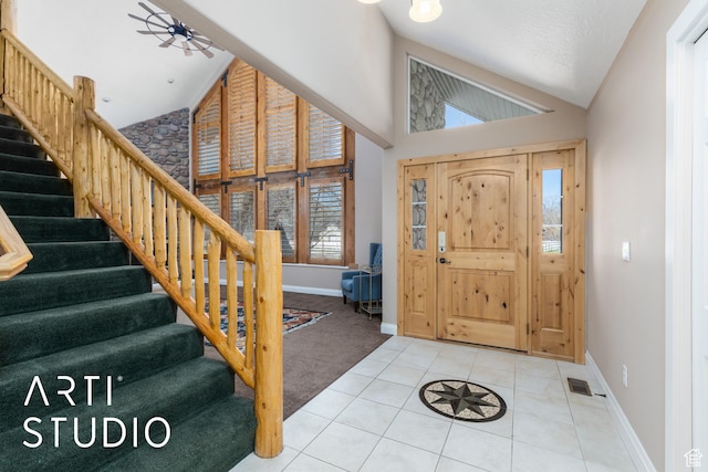 260 S 10450 E, Huntsville, UT 84317 - tiled foyer entrance with high vaulted ceiling, stairway, visible vents, and baseboards