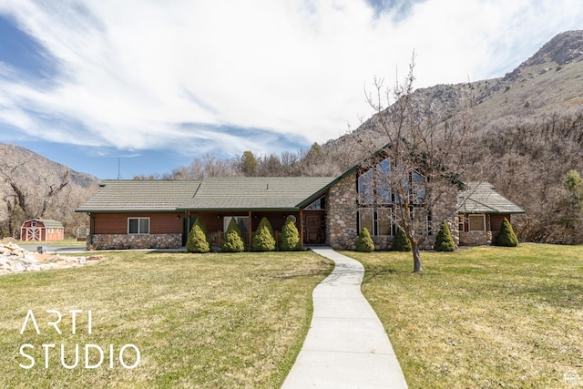 260 S 10450 E, Huntsville, UT 84317 - view of front of house featuring a mountain view, a shed, stone siding, an outdoor structure, and a front lawn