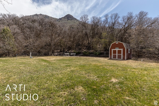 260 S 10450 E, Huntsville, UT 84317 - view of yard featuring a storage shed, a wooded view, a mountain view, and an outdoor structure