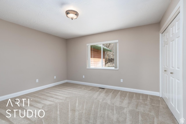 260 S 10450 E, Huntsville, UT 84317 - unfurnished bedroom featuring a closet, carpet, visible vents, and baseboards