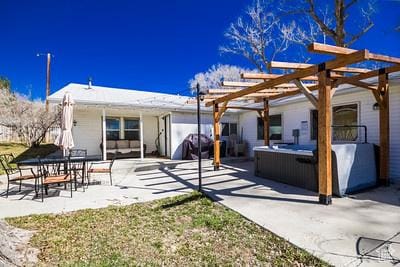 48 E 2nd N, Manila, UT 84046 - view of patio featuring a pergola and a hot tub