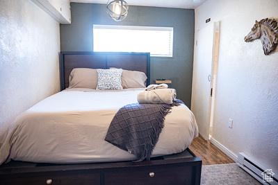 48 E 2nd N, Manila, UT 84046 - bedroom featuring a baseboard radiator, wood finished floors, and baseboards