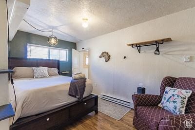 48 E 2nd N, Manila, UT 84046 - bedroom with a baseboard radiator, wood finished floors, and a textured ceiling