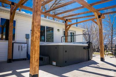 48 E 2nd N, Manila, UT 84046 - view of patio / terrace featuring a pergola and a hot tub