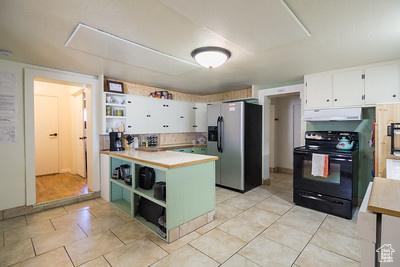 48 E 2nd N, Manila, UT 84046 - kitchen featuring stainless steel fridge with ice dispenser, electric range, open shelves, white cabinetry, and under cabinet range hood