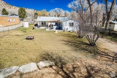 48 E 2nd N, Manila, UT 84046 - back of house featuring a mountain view, fence, and a patio