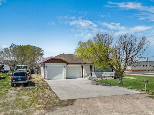 single story home featuring concrete driveway, roof with shingles, a garage, and a front lawn