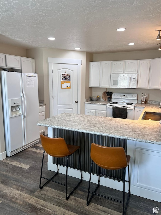 7777 N Mountain Ash Way, Eagle Mountain, UT 84005 - kitchen with a sink, white cabinets, white appliances, and a kitchen bar