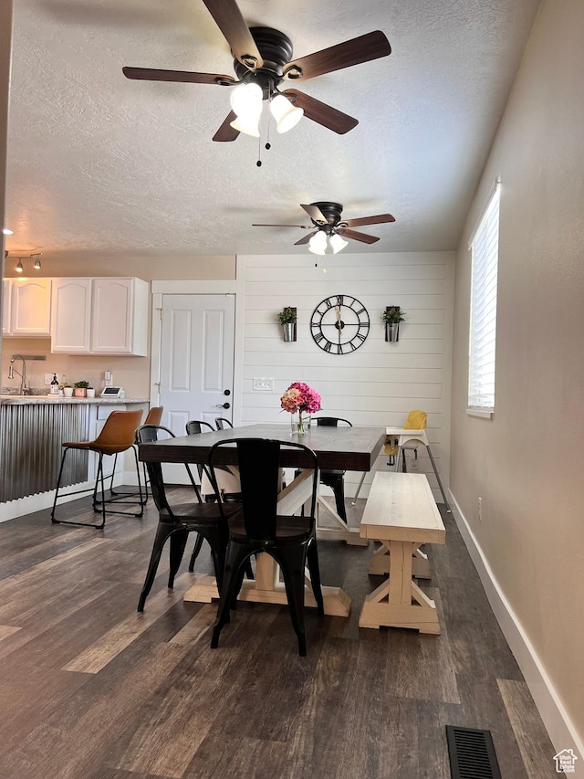 7777 N Mountain Ash Way, Eagle Mountain, UT 84005 - dining room featuring a textured ceiling, a ceiling fan, visible vents, dark wood-style flooring, and baseboards