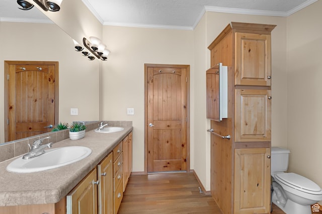 19185 N 11250 E, Mount Pleasant, UT 84647 - bathroom with a sink, ornamental molding, toilet, and wood finished floors