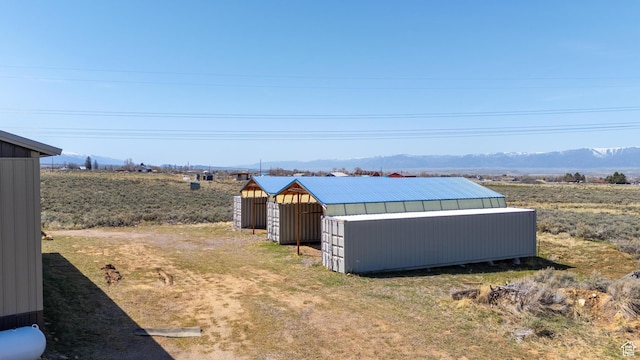 19185 N 11250 E, Mount Pleasant, UT 84647 - view of yard featuring an outbuilding, a mountain view, an outdoor structure, and a carport
