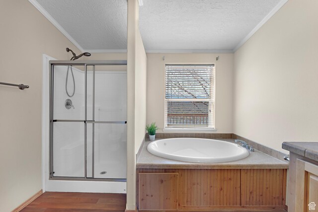 19185 N 11250 E, Mount Pleasant, UT 84647 - bathroom with a textured ceiling, crown molding, a shower stall, a bath, and wood finished floors