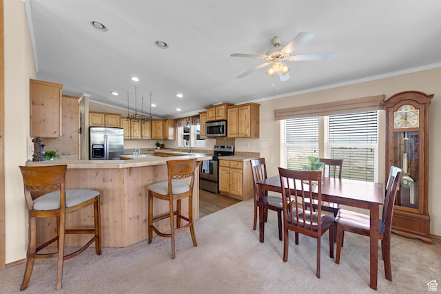 19185 N 11250 E, Mount Pleasant, UT 84647 - kitchen with light countertops, crown molding, stainless steel appliances, light colored carpet, and a breakfast bar area