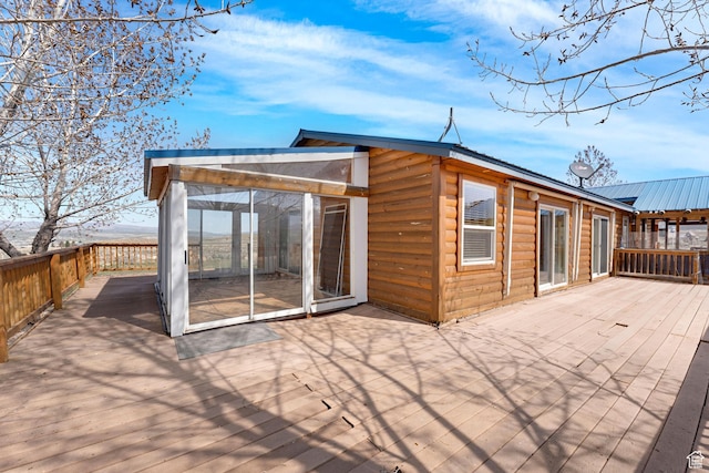 19185 N 11250 E, Mount Pleasant, UT 84647 - back of house with a sunroom, metal roof, faux log siding, and a deck