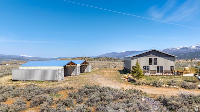 19185 N 11250 E, Mount Pleasant, UT 84647 - view of yard featuring a mountain view, a pole building, an outdoor structure, and fence