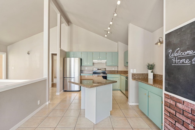 kitchen featuring light tile patterned flooring, high vaulted ceiling, a center island, under cabinet range hood, and stainless steel appliances