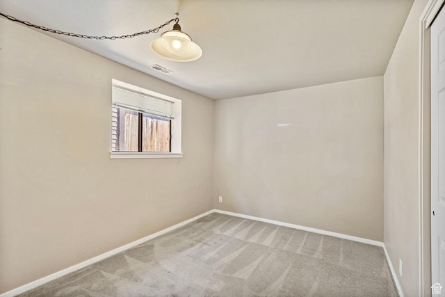 unfurnished room featuring visible vents, carpet flooring, and baseboards