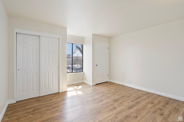 unfurnished bedroom with baseboards and light wood finished floors
