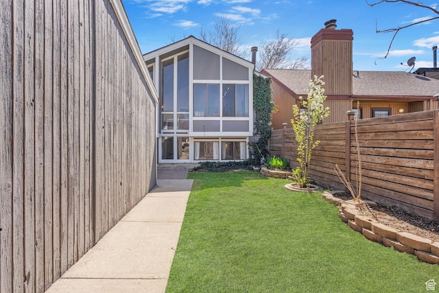view of yard with fence and a sunroom
