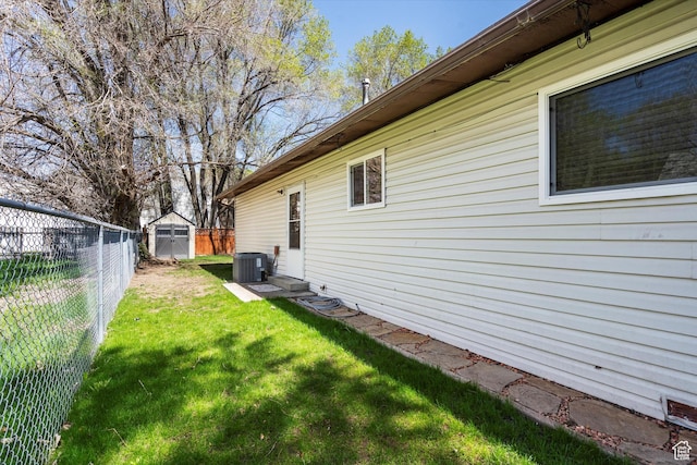 486 13th St, Ogden, UT 84404 - view of yard with a shed, an outdoor structure, central AC, and a fenced backyard