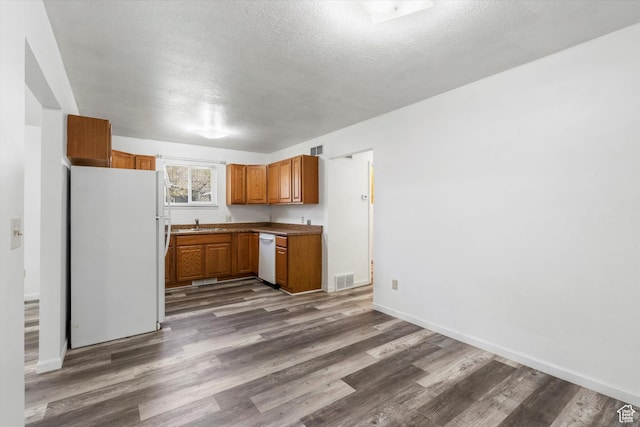 486 13th St, Ogden, UT 84404 - kitchen with dark wood-style floors, a textured ceiling, brown cabinets, and white appliances